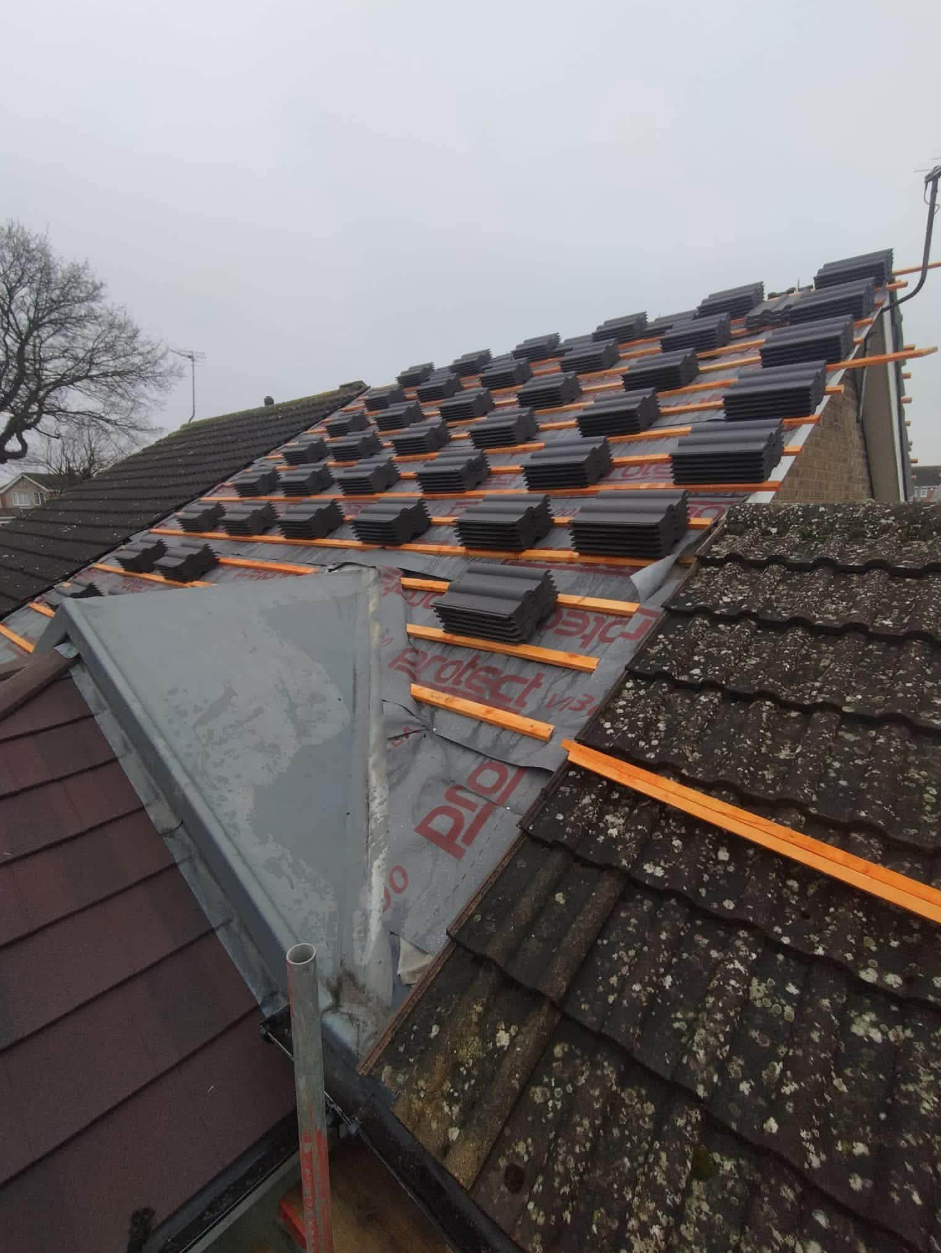 Roof tiling in progress with battens and membrane